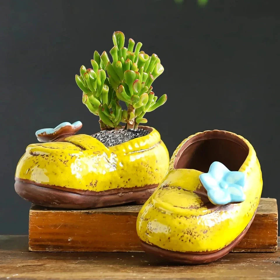 Charming ceramic boot-shaped vase with a glazed finish, perfect for displaying succulents and flowers in your home or garden