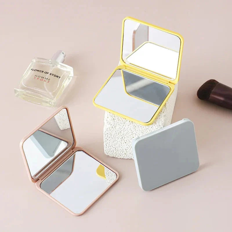 Portable Folding Double-Sided Makeup Mirror in Blue, Pink, Black, and Silver Colours