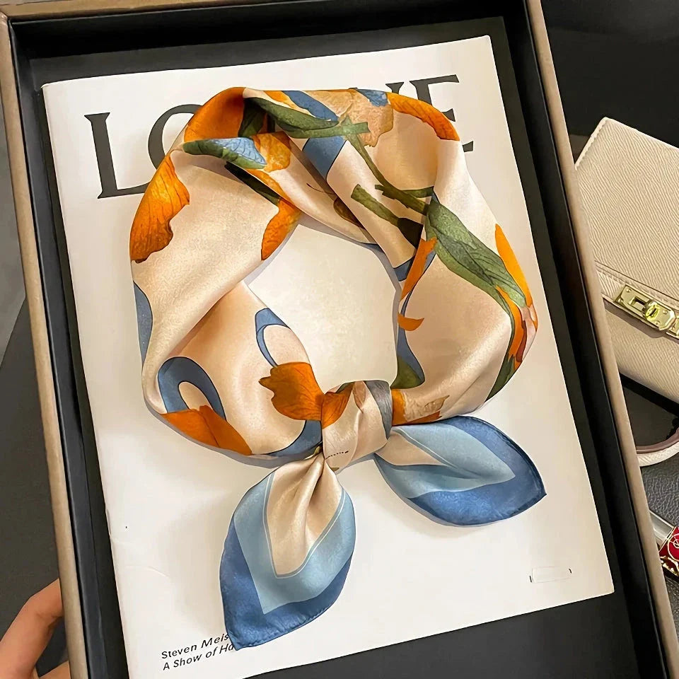 Luxurious floral 100% silk square scarf for women, featuring a charming print and versatile design.