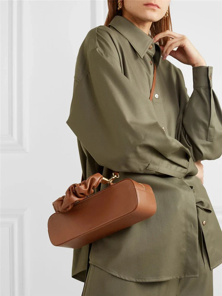 Sophisticated long shoulder diagonal bag with a sleek horizontal square design, made of durable synthetic leather and featuring a single shoulder strap for hands-free convenience.