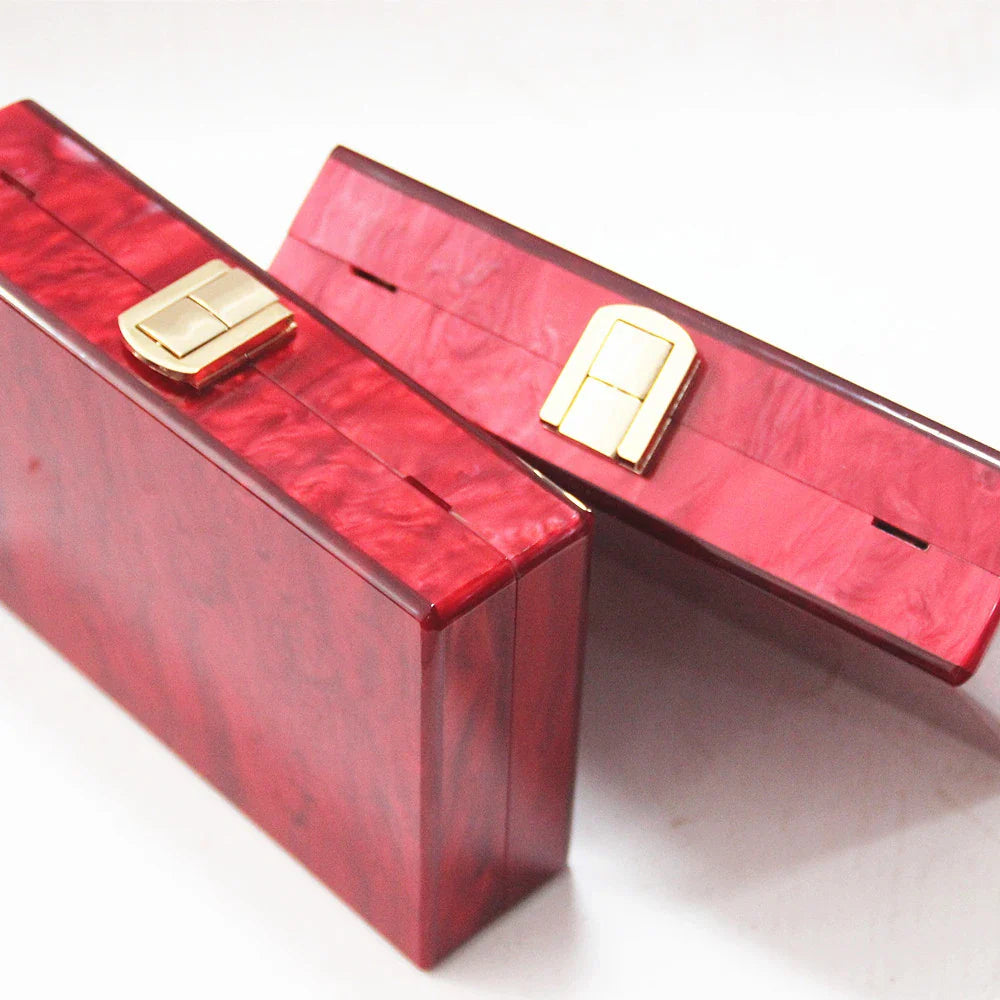 Stylish pearlescent acrylic clutch bag in red colour with a structured, square-shaped design
