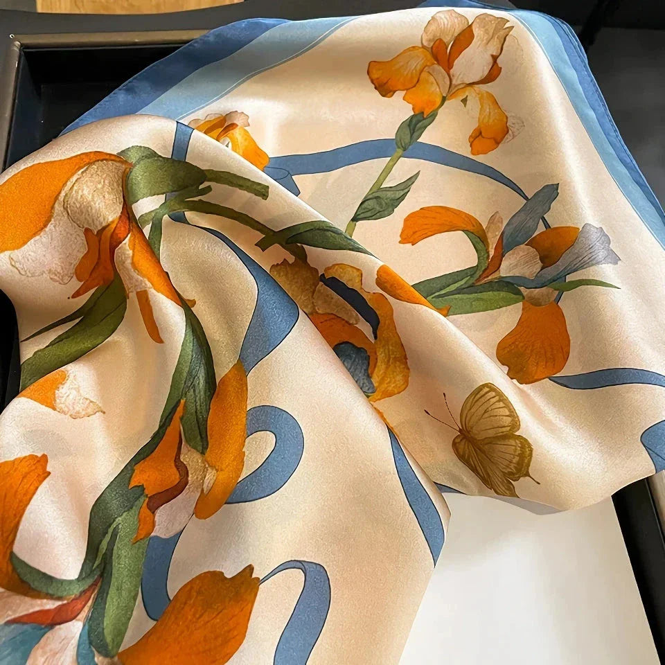 Luxurious floral 100% silk square scarf for women, featuring a charming print and versatile design.