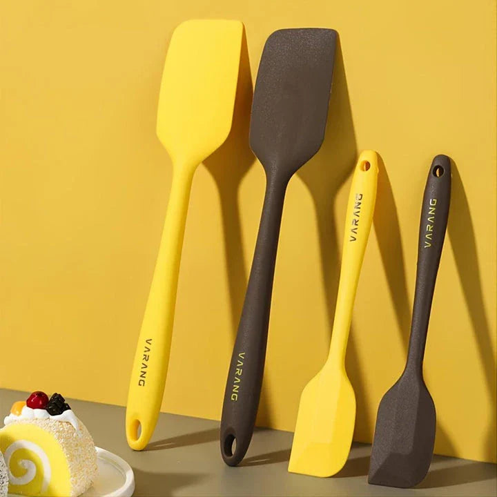 A set of two high-quality silicone spatulas in brown and yellow colours, designed for versatile cooking and baking tasks.
