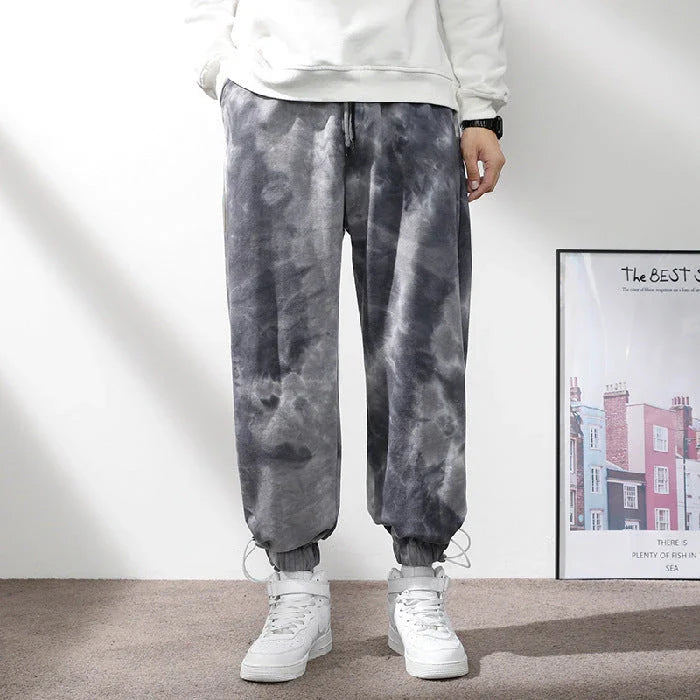 Stylish ankle-tied sweatpants in camouflage black, featuring an elasticated waistband, drawstring, and ankle ties for a relaxed yet refined look.