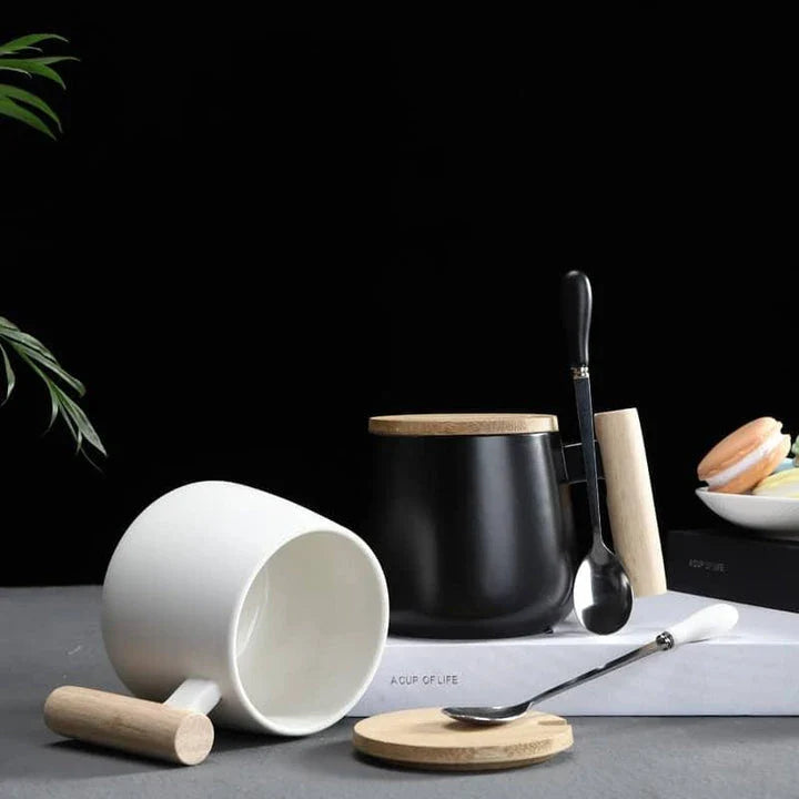 A stylish ceramic coffee mug with a colour block design and a coordinating wooden spoon