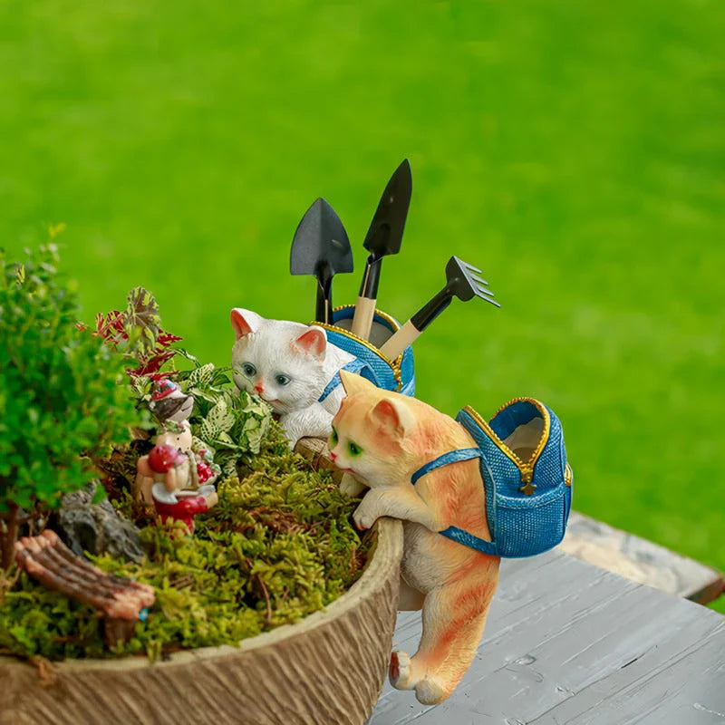 A charming resin cat figurine wearing a stylish backpack, serving as a unique garden decoration and practical storage solution.