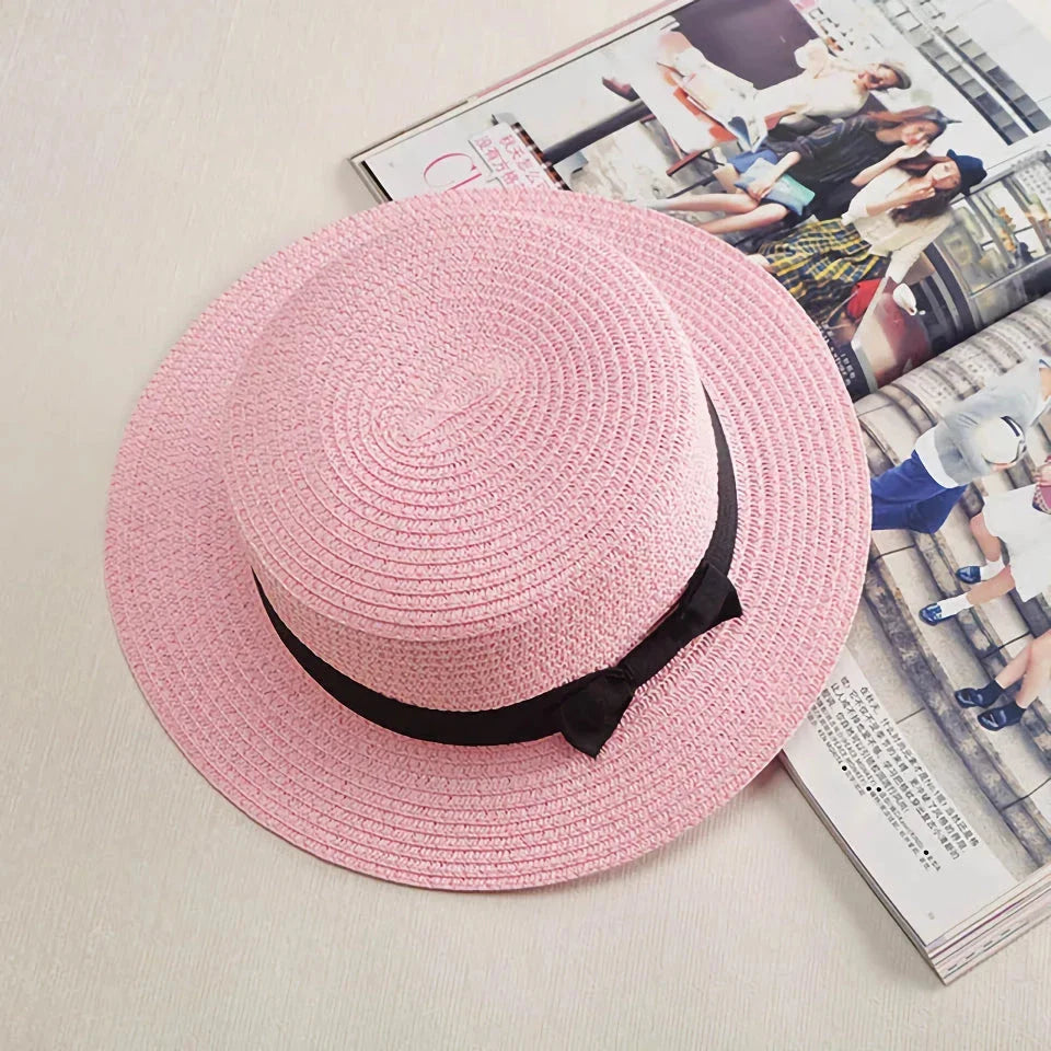 A classic summer Panama hat made from straw and paper, featuring a charming bow detail that adds a feminine touch.