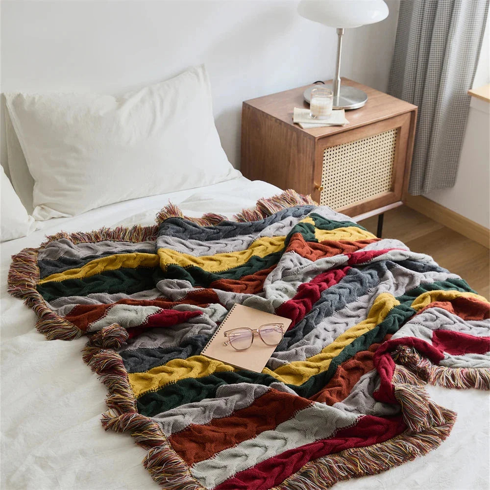 Elegant wool blanket with stylish plaid pattern and fringed tassels, perfect for cosy home decor and outdoor adventures.