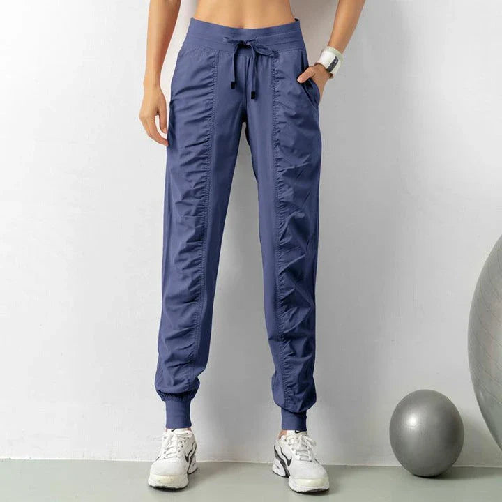 Premium women's sports trousers with drawstring waist and pockets, made of high-quality nylon fabric for comfort and versatility.