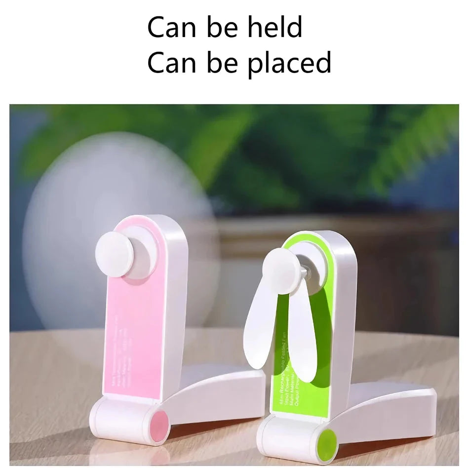 Compact rechargeable handheld fan in pink and green colours, providing powerful cooling on the move