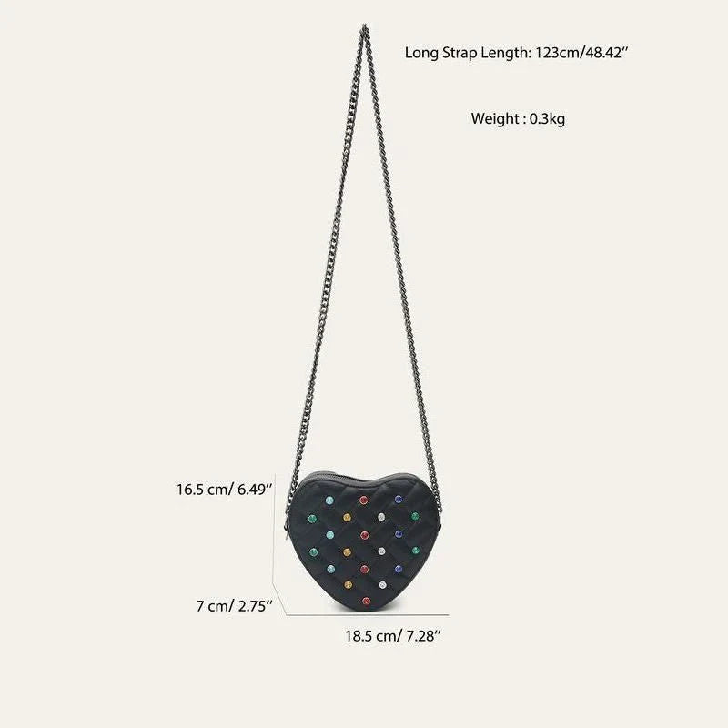 A stylish heart-shaped vegan leather crossbody bag with colourful rhinestone detailing, a versatile and fashionable accessory.