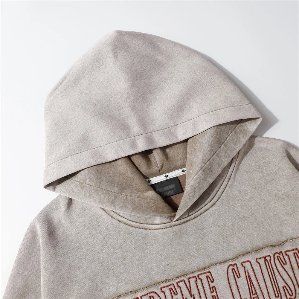 Embroidered cotton hoodie with a letter patch design, available in brown, grey, and black colours and sizes S to XL