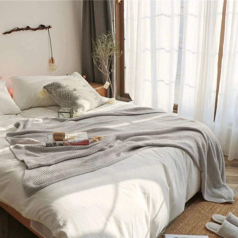 Cosy and sophisticated oversized moss stitch knitted blanket in various colours, perfect for adding warmth and style to any living space