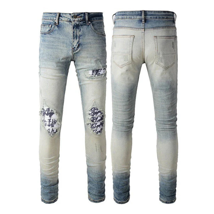 Stylish ripped denim jeans with a unique black and white patch design, perfect for British gentlemen