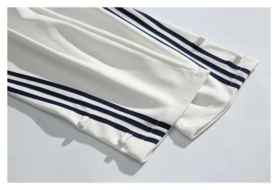 Stylish striped sports trousers in a relaxed, mid-waist design for versatile leisure and athletic wear