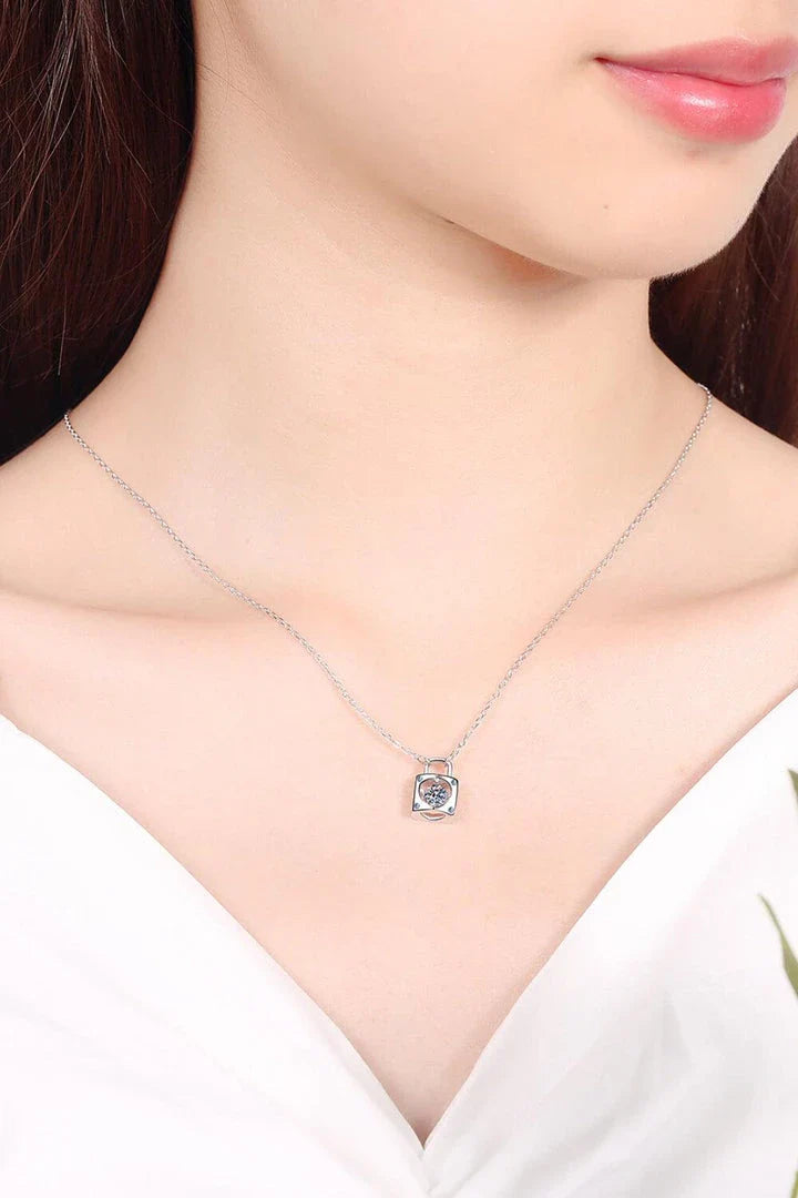 Elegant sterling silver moissanite lock pendant necklace with a minimalist, modern design