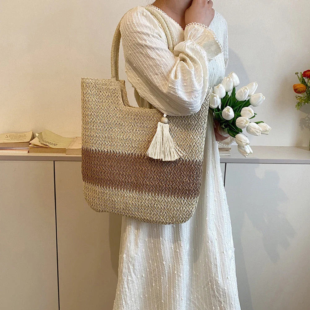 Stylish bohemian-inspired woven tote bag with contrasting tassels, perfect for summer outings