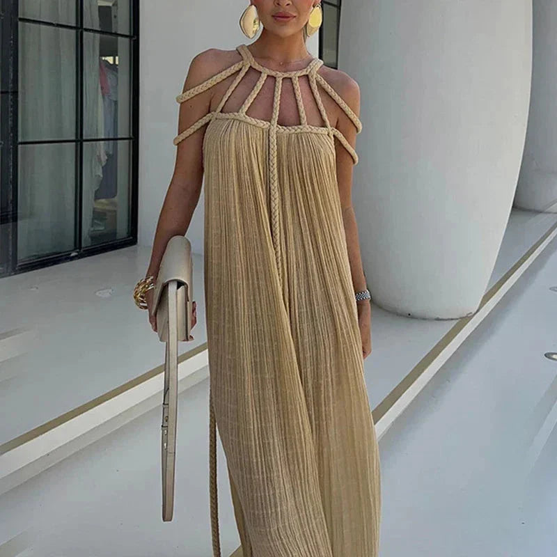 A stylish and sophisticated hollow out knitted beach dress in a beige colour, perfect for summer beach and poolside wear.