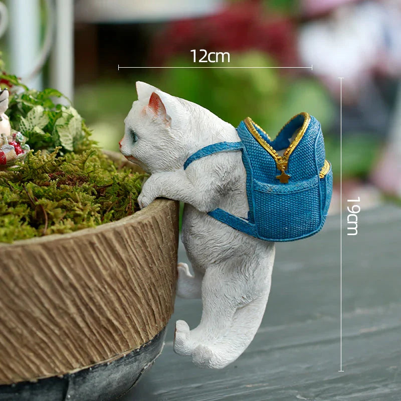 A charming resin cat figurine wearing a stylish backpack, serving as a unique garden decoration and practical storage solution.