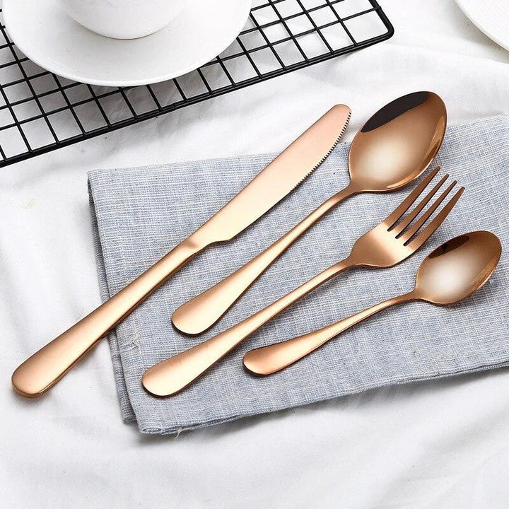 Premium eco-friendly stainless steel tableware set including knife, fork, spoon, and tea spoon in a sophisticated frosted finish