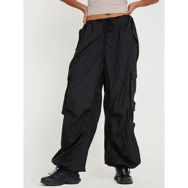Stylish high-waist safari-inspired cargo trousers for women in black, featuring a comfortable, flattering fit and practical pockets.