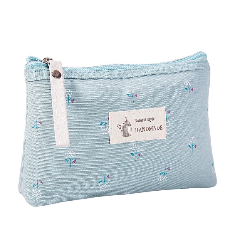 A stylish floral canvas cosmetic bag with a secure zipper closure, perfect for organising and carrying your makeup and toiletries while traveling.