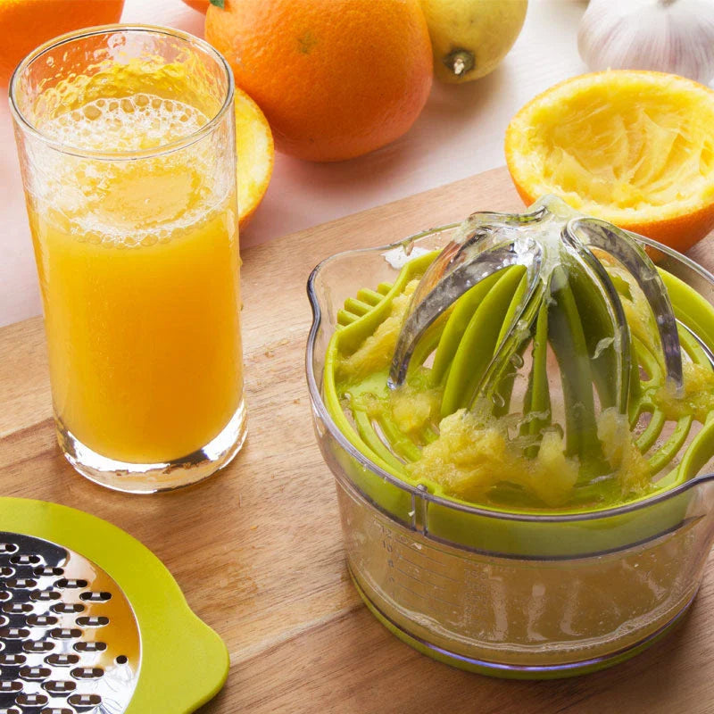 A manual citrus juicer with a built-in measuring cup, grater, and egg separator for versatile kitchen tasks