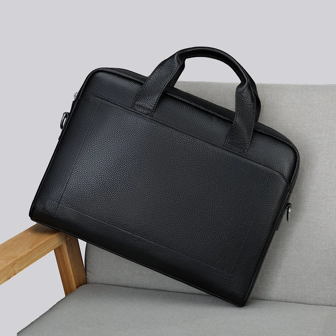 Men's genuine leather briefcase in dark coffee colour, featuring a spacious interior and adjustable shoulder strap for versatile carrying