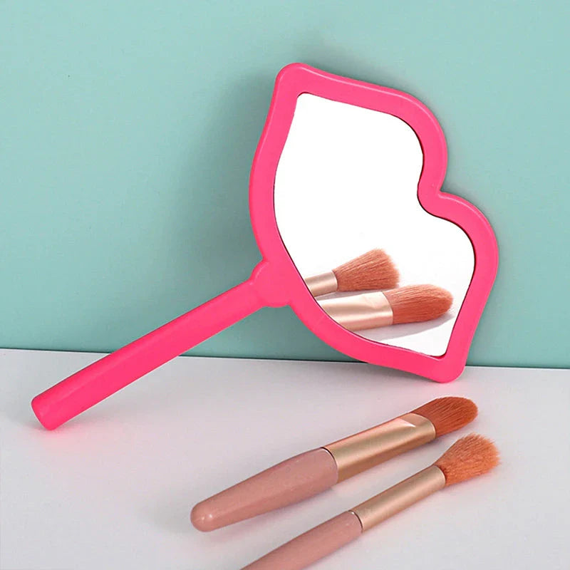 Lip-shaped handheld makeup mirror with a comfortable ergonomic handle for precise on-the-go touch-ups