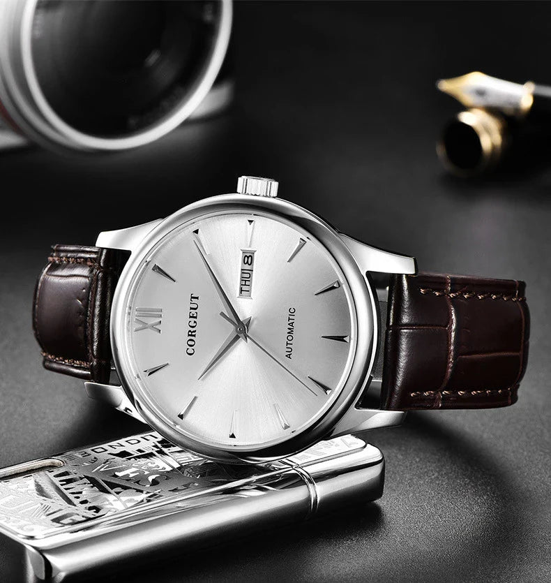 A sophisticated automatic mechanical watch with a gold/white or gold/black face, stainless steel case, and genuine leather strap