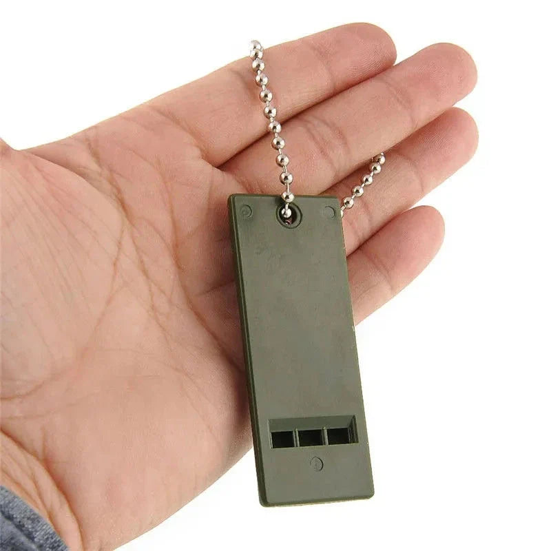 High-decibel outdoor survival whistle in dark green, made of durable polystyrene material for long-lasting use
