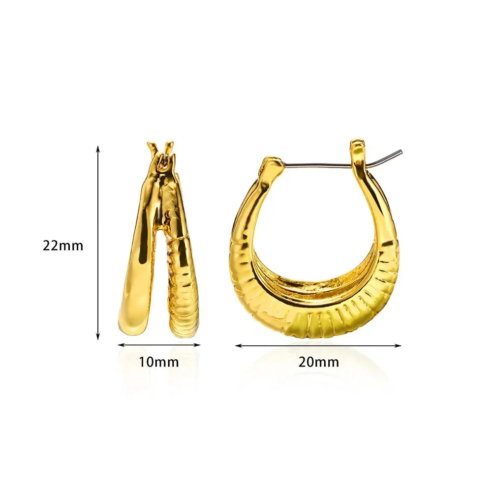 A pair of gold-toned stainless steel hoop earrings, showcasing a classic and sophisticated design