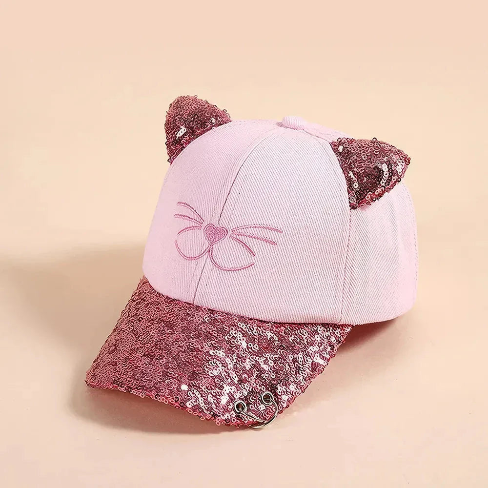 A playful, embroidered kids' baseball cap in a vibrant red panda colour, featuring a cute cartoon cat design and shimmering sequin accents.