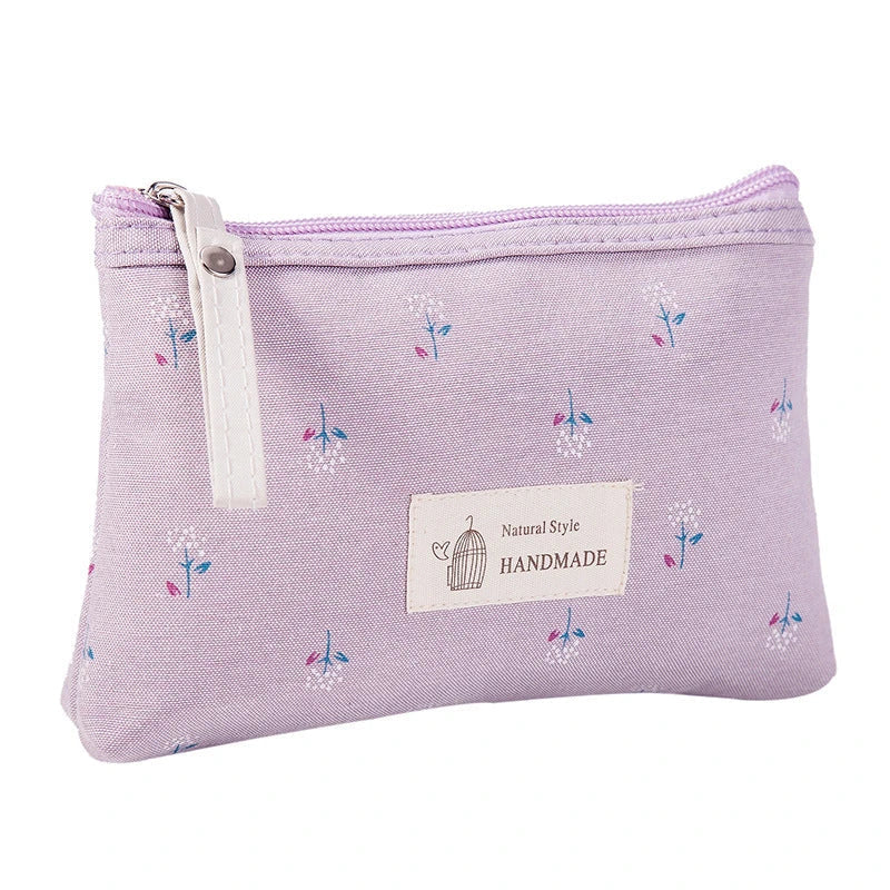 A stylish floral canvas cosmetic bag with a secure zipper closure, perfect for organising and carrying your makeup and toiletries while traveling.