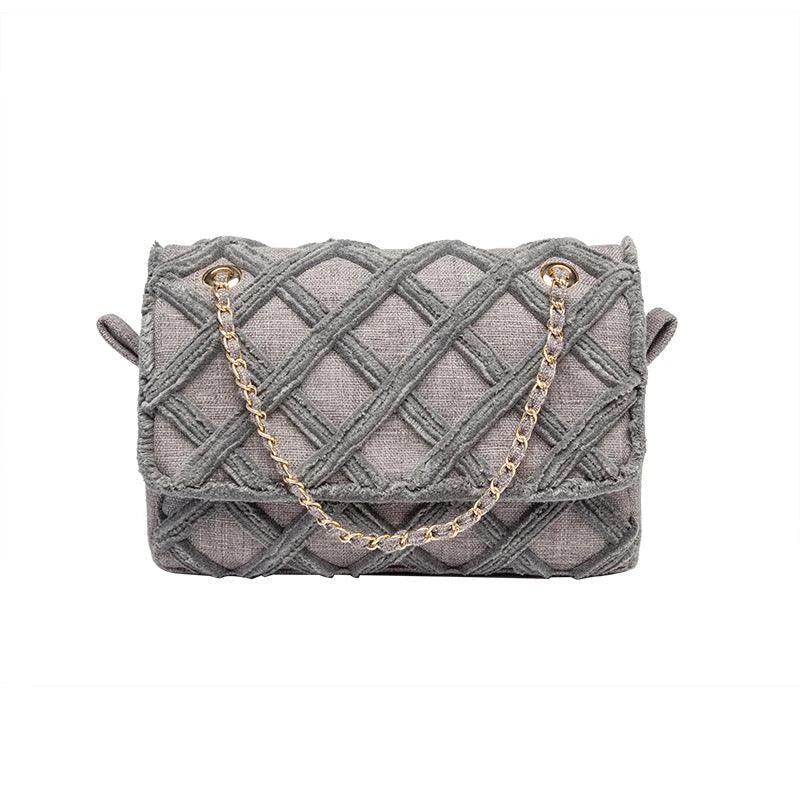 A stylish, retro-inspired shoulder bag with a minimalist rhombus pattern design, perfect for the modern, fashion-conscious woman in the UK.