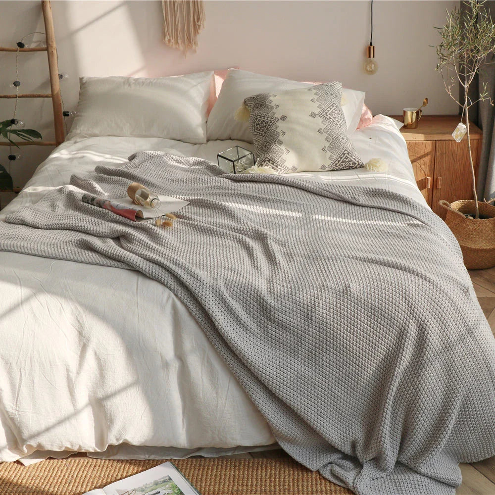 Cosy and sophisticated oversized moss stitch knitted blanket in various colours, perfect for adding warmth and style to any living space
