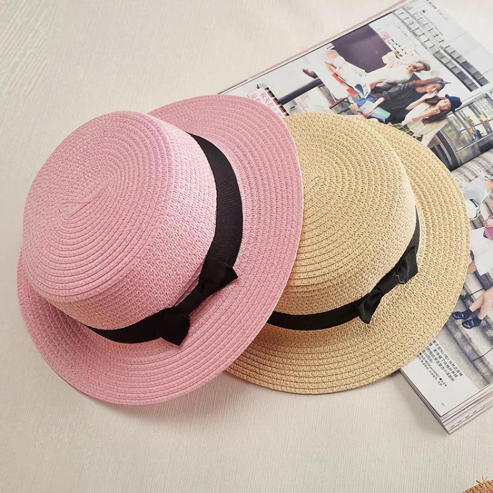 A classic summer Panama hat made from straw and paper, featuring a charming bow detail that adds a feminine touch.