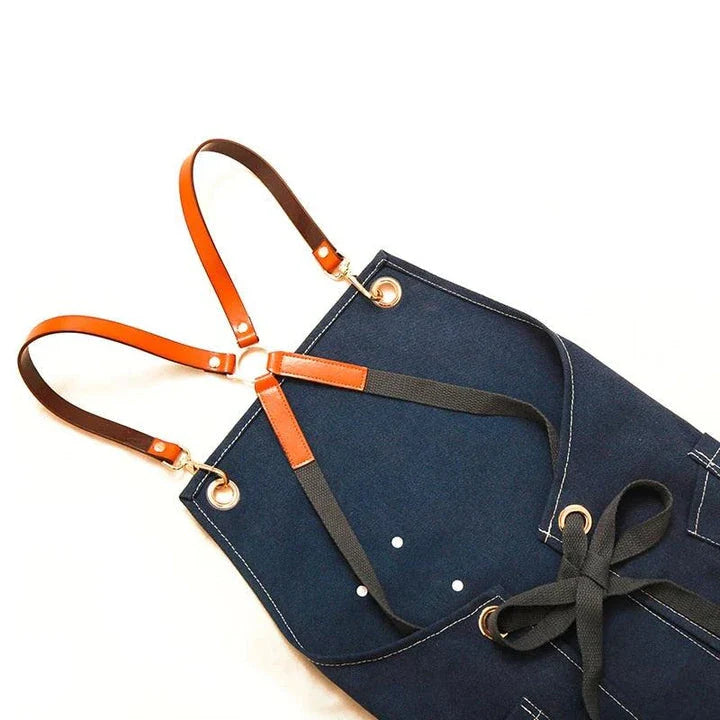 Premium canvas barista apron with British-inspired design, perfect for protecting clothing while crafting coffee.