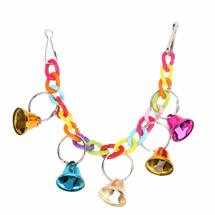 Acrylic bird bells swing with intricate design, hanging in a lush garden setting