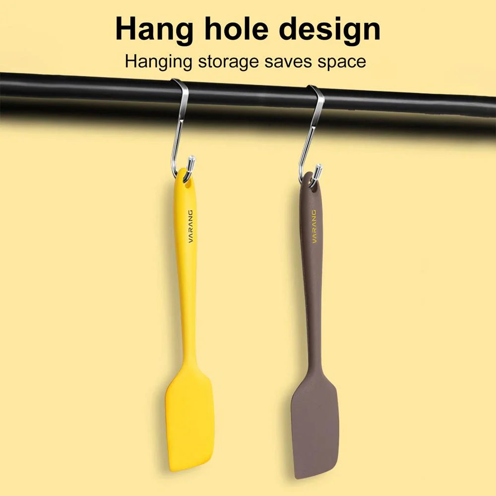 A set of two high-quality silicone spatulas in brown and yellow colours, designed for versatile cooking and baking tasks.