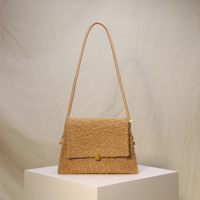 A stylish faux lamb wool crossbody bag in beige, black, or khaki brown with a contemporary design and practical storage features