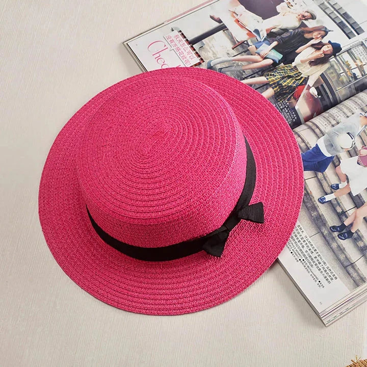 A classic summer Panama hat made from straw and paper, featuring a charming bow detail that adds a feminine touch.