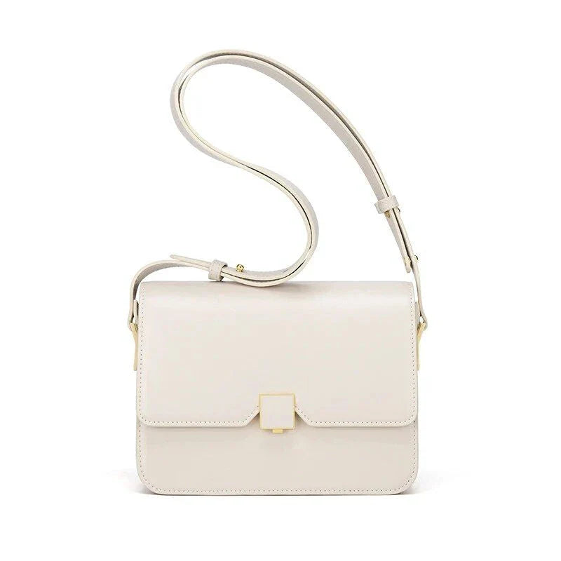 Stylish British-inspired leather shoulder and crossbody bag in black, tan, and navy colours