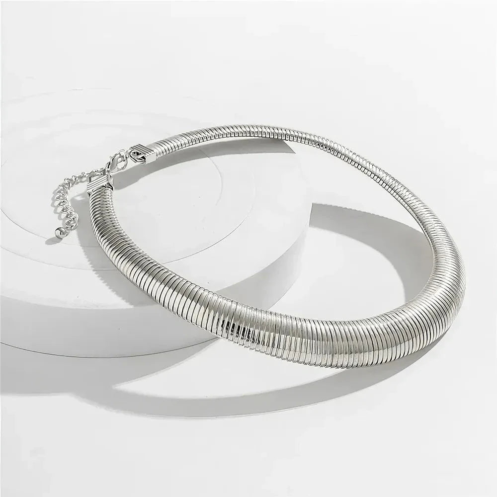 Captivating spiral chunky choker necklace in gold and silver colours, featuring a bold, geometric design for a unique, statement-making look.