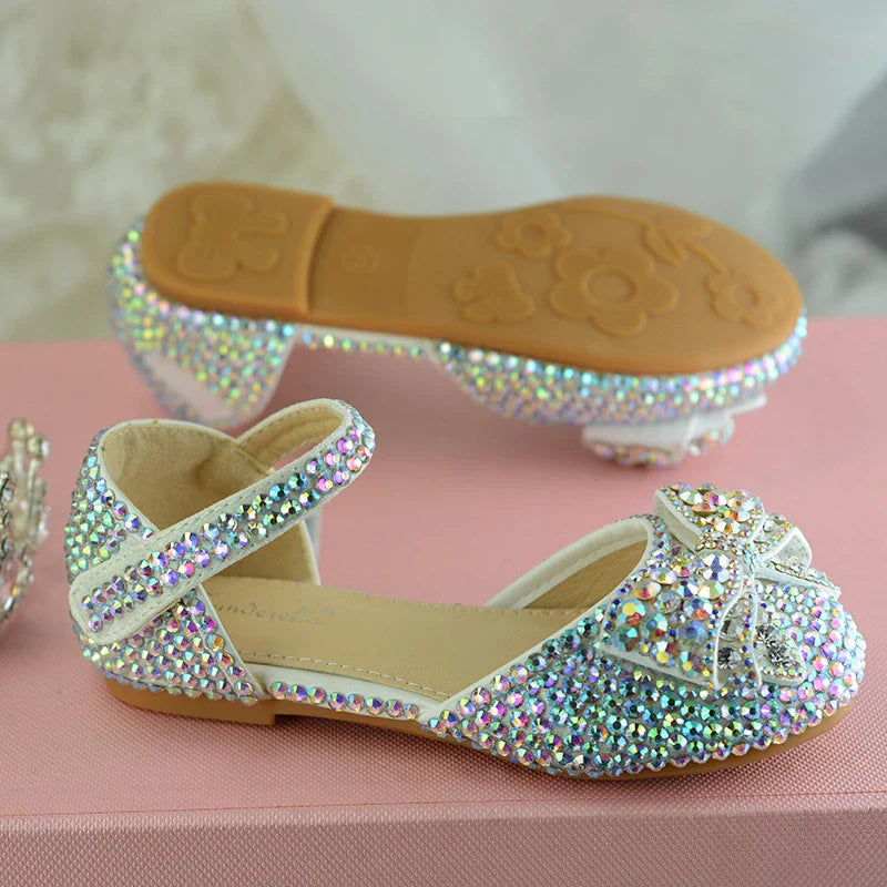 Enchanting princess crystal shoes with bow detail and dazzling crystals, perfect for girls' special occasions