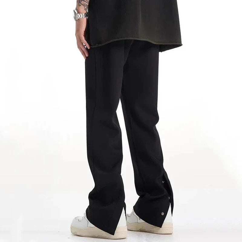 Sophisticated retro-style casual suit trousers in black and apricot colours, featuring a sleek straight-leg silhouette and distinctive back slit