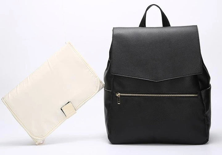 A stylish and practical PU leather mummy bag with a large capacity, multiple pockets, and included accessories like a changing pad and stroller hooks.