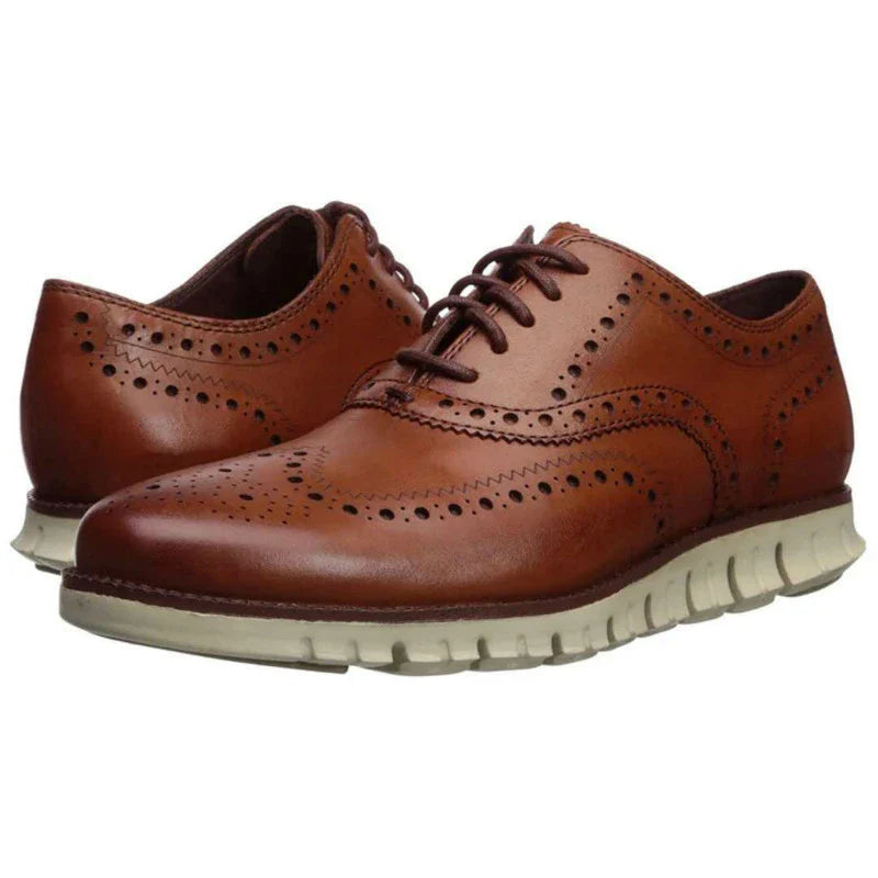 A pair of premium leather business shoes with a thick rubber sole and a stylish leather toe cap, available in brown and black colours.