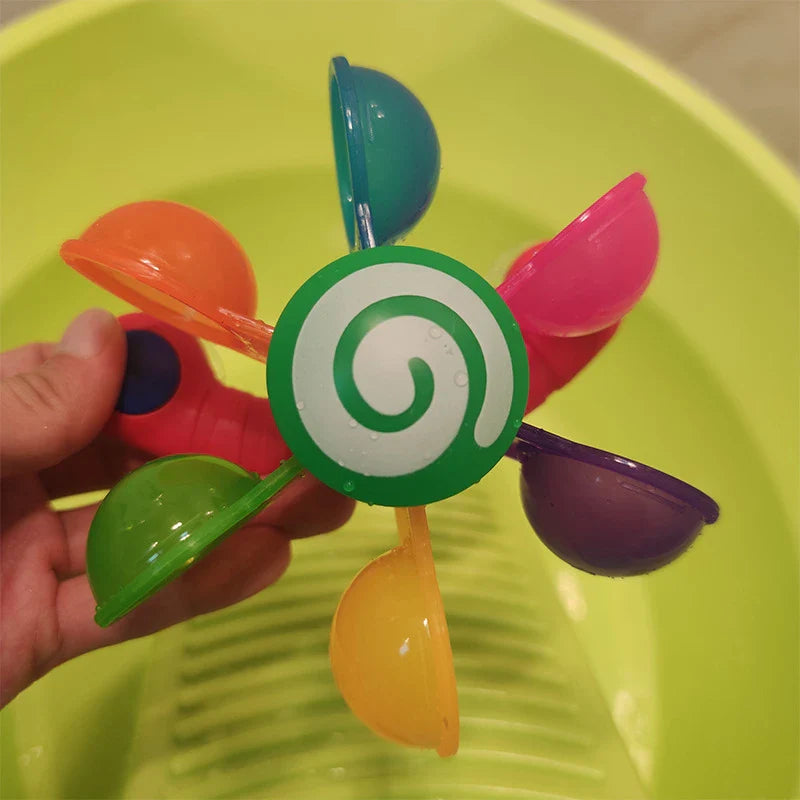 Colourful children's bath toy with a turning windmill and spoon for imaginative water play