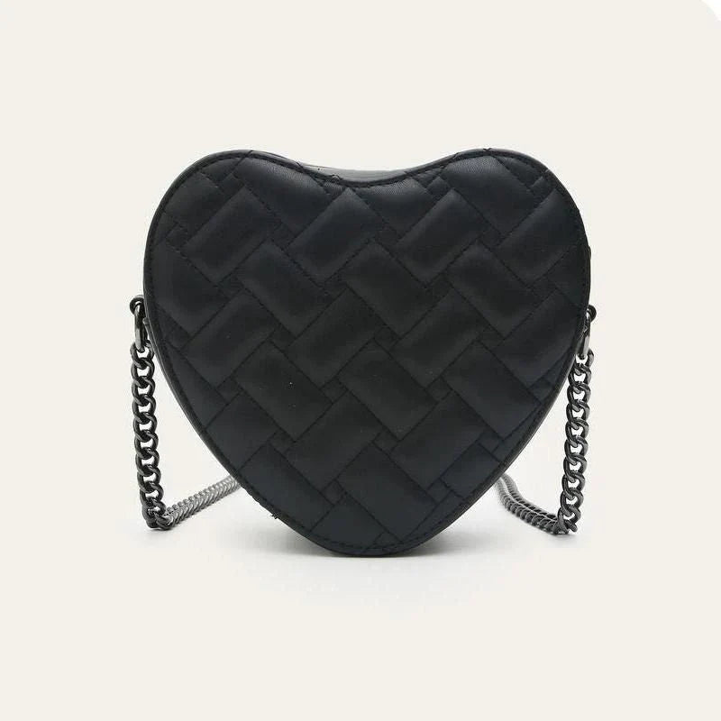 A stylish heart-shaped vegan leather crossbody bag with colourful rhinestone detailing, a versatile and fashionable accessory.